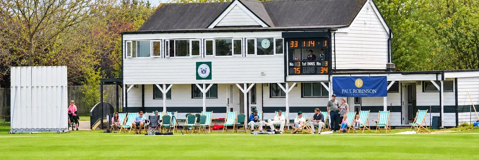 The Southend-on-Sea & EMT Cricket Club pavilion with deckchairs on the boundary